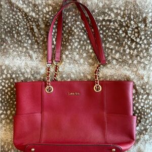 Calvin Klein red tote bag with chain link handles.